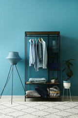 Poster - Interior of dressing room with shelving unit, clothes and lamps