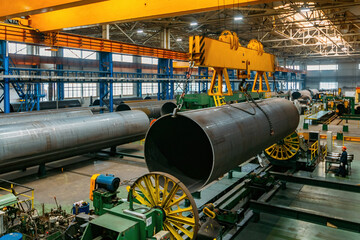 Finished pipe transportation by overhead crane in pipe factory