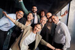 © CarlosBarquero - Portrait of excited funny multi-ethnic staff people business team stand in office looking at camera. Happy diverse professional colleagues group celebrate success win victory reward at corporate party