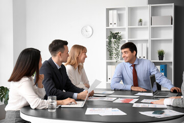 Canvas Print - Group of business consultants working in office