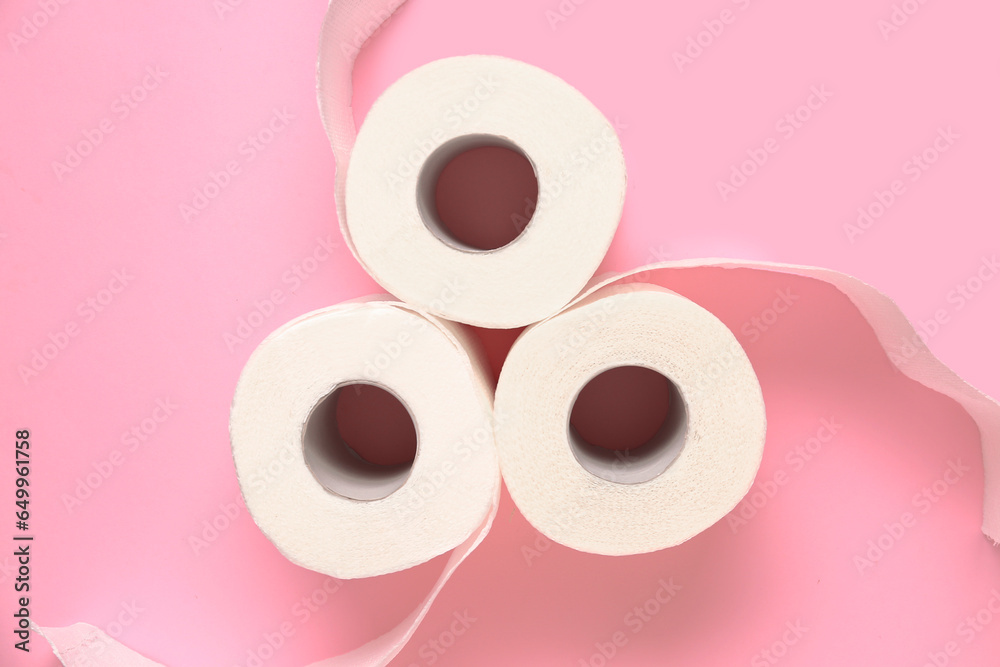 Rolls of toilet paper on pink background