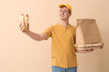 Wall Mural - Delivery service worker with tasty food on beige background