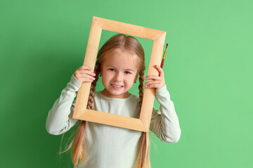 Sticker - Cute little girl with paint brush and frame on green background