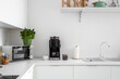 © Pixel-Shot - Interior of modern kitchen with coffee machine on white counter