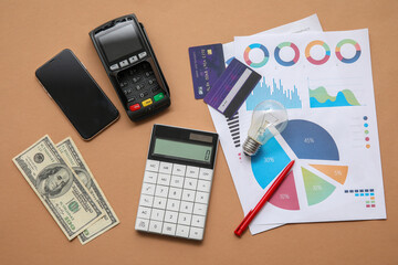 Wall Mural - Calculator, credit cards, smartphone and charts on brown background. House rent concept