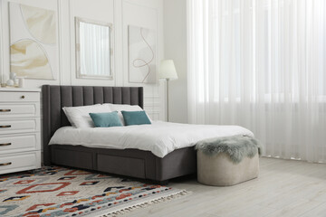 Sticker - Large comfortable bed with cushions in bedroom. Interior design