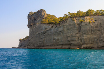 Wall Mural - View of the rocky shore from the sea. Mediterranean Sea in Turkey. Popular tourist places. Background