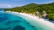 Aerial view of beautiful tropical island with white sand, turquoise water and blue sky.