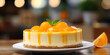 Delicious and creamy mandarin clementine cheese cake on plate, blurred background 