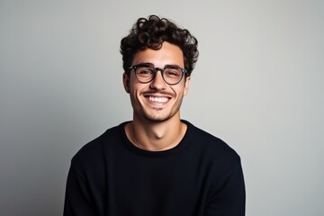 portrait of a handsome young man wearing glasses and looking at camera.
