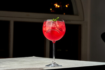 Wall Mural - Rum-based alcoholic cocktail with strawberries and coconut in a glass on a dark background. Bar menu