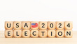 USA 2024 presidential election concept. Wooden block with text and american flag