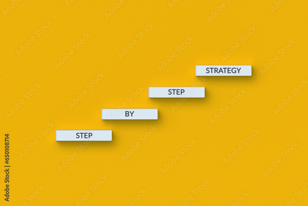 The words step by step strategy on blocks. Business concept. Persistent ...