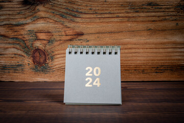 2024 cardboard desk calendar on a wooden texture background