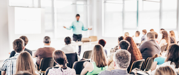 Speaker at business workshop and presentation. Audience at the conference room.