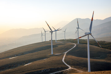 natural technology of a wind farm with the clouds located in the mountains of italy europe and allow