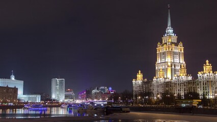 Wall Mural - Winter Night Timelapse Hyperlapse of Hotel Ukraine, One of the Seven Sister Skyscrapers in Moscow, Russia. Iconic Landmark from Stalin's Era, Illuminated Cityscape with reflections on a River