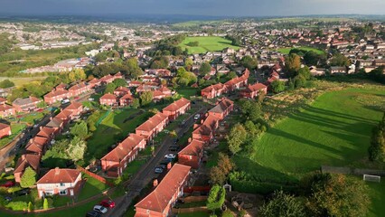 Wall Mural - UK city living: Yorkshire's red brick council estate, aerial view, morning sun, active community, residents.