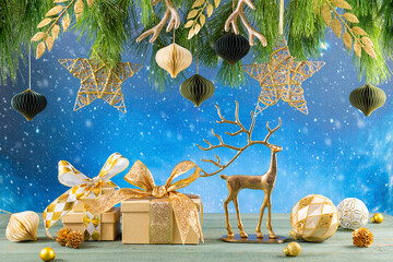 Wall Mural - Christmas or New Year festive composition. Fir branches, gold Christmas decorations,balls and gift boxes on wooden table.