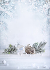 Wall Mural - christmas still life with snowy pine cones, baubles and fir branches on light background. winter or 