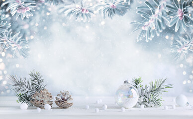 Wall Mural - Winter background with snowy fir branches, pine cones and transparent Christmas ball. Winter or Christmas festive scene.