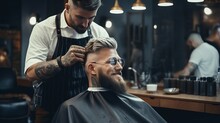A Hairdresser Cuts A Man's Hair With Scissors In A Barbershop.