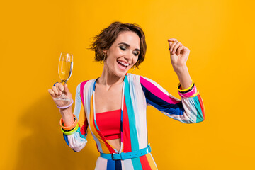 Poster - Photo of funny shiny woman dressed striped suit having fun drinking wine isolated yellow color background