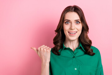 Sticker - Photo of pretty impressed woman dressed green shirt showing thumb empty space isolated pink color background