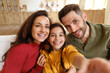 © Prostock-studio - Daughter making selfie photo with daddy and mommy at home