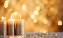Golden Candles On A Wooden Table.