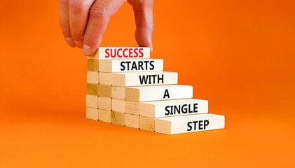 Wall Mural - Success symbol. Concept words Success starts with a single step on wooden block. Beautiful orange table orange background. Businessman hand. Business success starts with single step concept Copy space