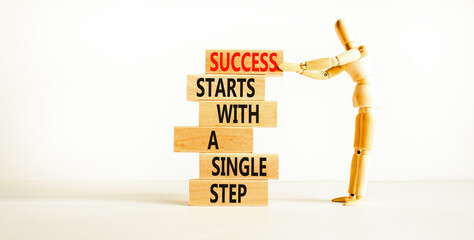 Wall Mural - Success symbol. Concept words Success starts with a single step on wooden block. Beautiful white table white background. Businessman icon. Business success starts with single step concept. Copy space.