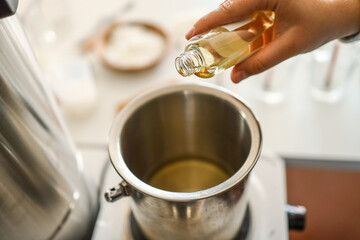 Wall Mural - Woman pouring scent for candles, manufacturing process