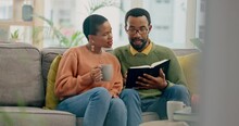 Home, Prayer Or Black Couple Reading A Book Together In A Christian Home In Retirement For Hope Or Faith. Jesus, Man Or African Woman Studying Bible For Love, Gratitude Or Support In Religion At Home