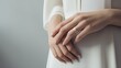 © lililia - the graceful hand of a bride wearing a diamond engagement ring, with a focus on minimalism and light colors to accentuate the beauty of the moment.