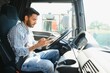 © Serhii - Young handsome indian man using smart phone in his truck.