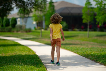 Sticker - Child running in summer street. Kid enjoy run. Kid running on neighborhood. Kids run on city running road. Happy childhood. Child boy running in the park. Sports and fitness, exercise for kids.