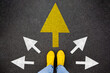 © olyphotostories - Feet walking away with directions arrow. Taking main decision for the future. Sneaker shoes top view road. Hipster woman standing on floor or pathway to success. Creative idea, future concept