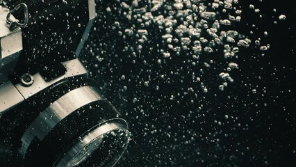 Canvas Print - Closeup of a camera dropping in black water