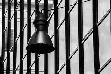 Sticker - black and white image of a street light against the glass of a building