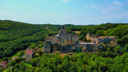 Poster - Drone flyover Castelnaud-la-Chapelle Castle with wood trees under  blue sky in France