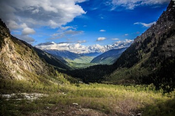 Sticker - Beautiful view of a green landscape with mountains under the blue sky