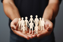 Person Is Seen Holding Paper Cutout Of Family. Various Contexts, Such As Family, Relationships, Diversity, Or Even Advertising Campaigns Promoting Unity And Togetherness.