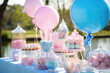 A colorful and delicious dessert table filled with sweet treats, cupcakes and pastries for a joyful gender party.