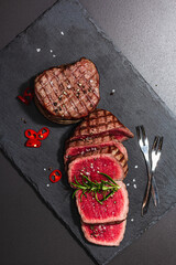 Wall Mural - Rare cooking level Eye round steak with spices and herbs. Classic grilled meat cut ready to eat