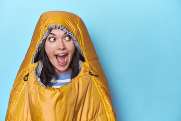 Young woman cozy inside camping sleeping bag