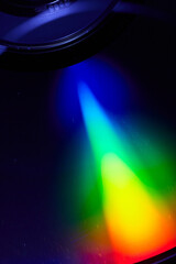 Black alien like saucer with rainbow beam of light abstract art background asset