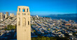 Top of Coit Tower aerial late afternoon view of city and distant Golden Gate Bridge