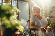 Senior woman in wheelchair happily laughing.  Lifestyle portrait. 