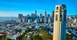 Aerial Coit Tower with San Francisco downtown in background and Oakland Bay Bridge